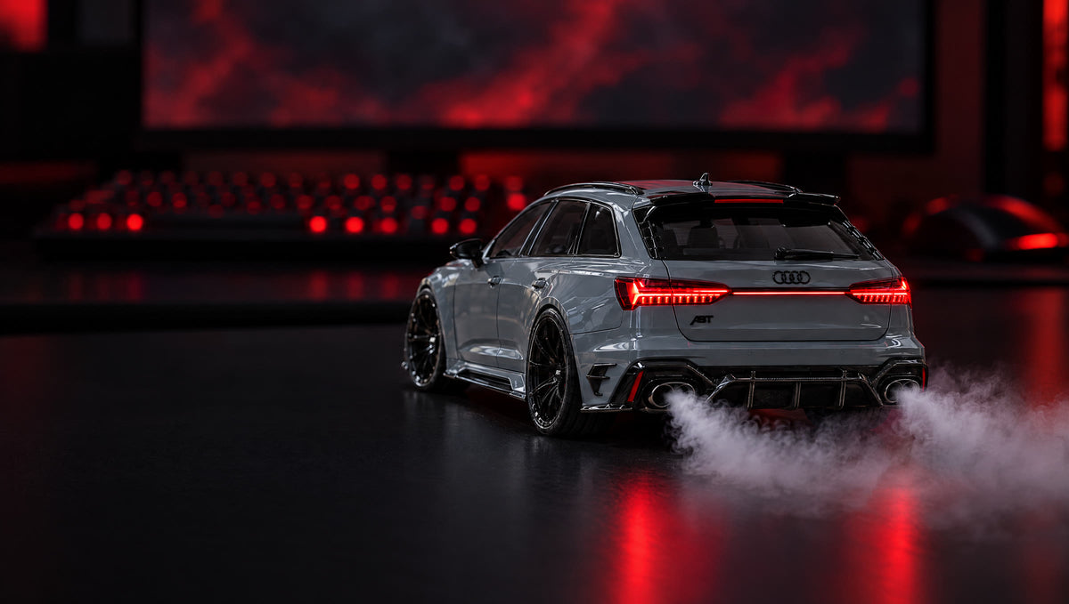 Nardo grey Audi RS6 ABT MistGarage model car with mist coming out of the exhaust, on a gaming desk at night