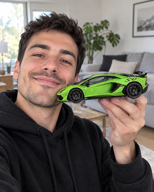Man holding a green Lamborghini SVJ MistGarage model car up to the camera